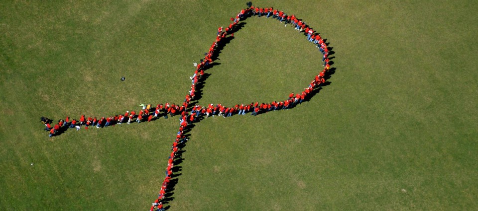 Vermont CARES volunteers forming AIDS sign